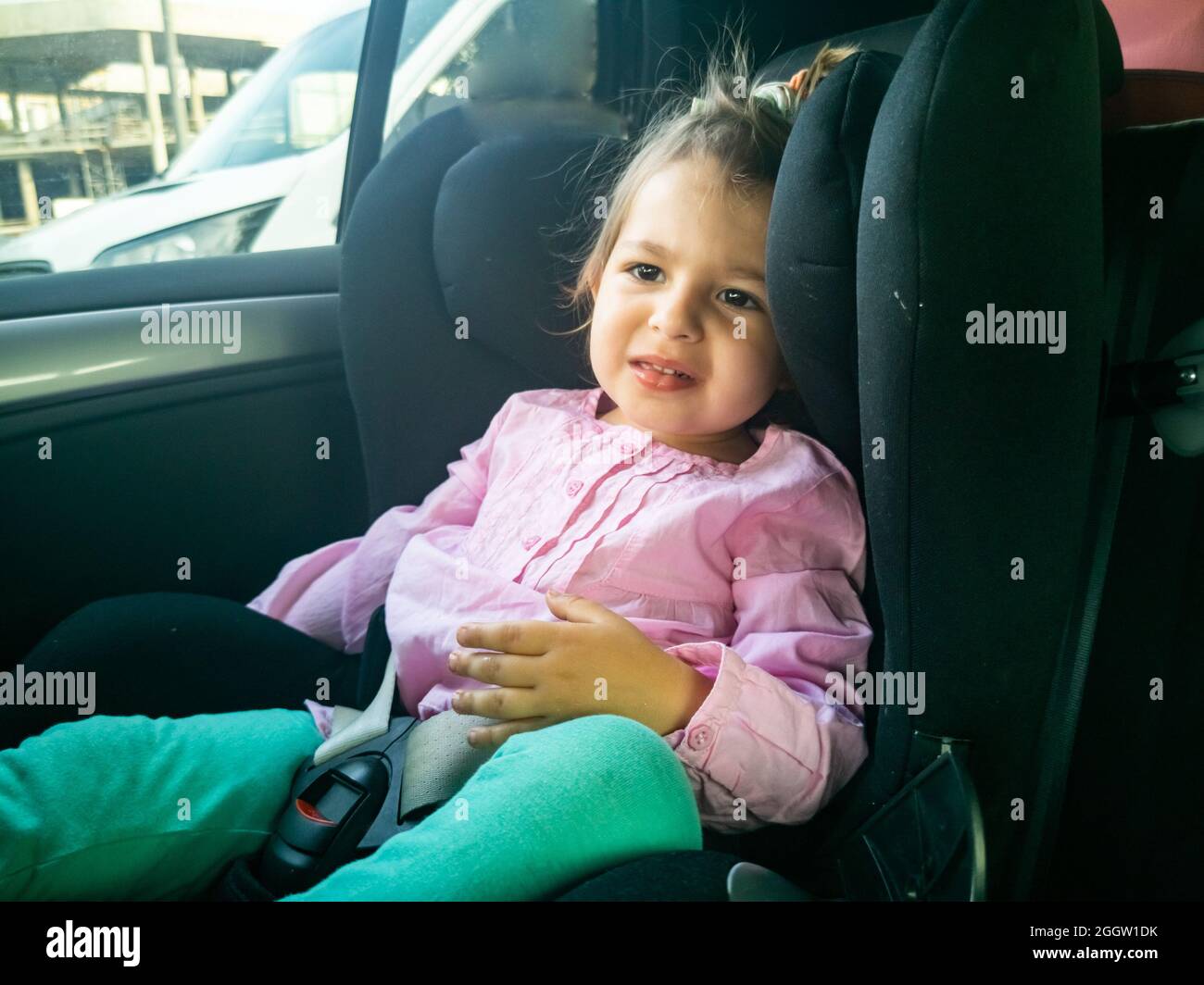 the child was seasick in the car. sad toddler sitting in a child seat