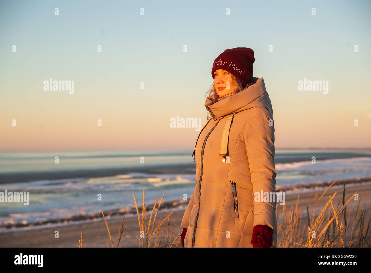 Winter Lifestyle Portrait of Beautiful Woman , Winter Solstice and Feelings concept with sunset light nature on background. Stock Photo