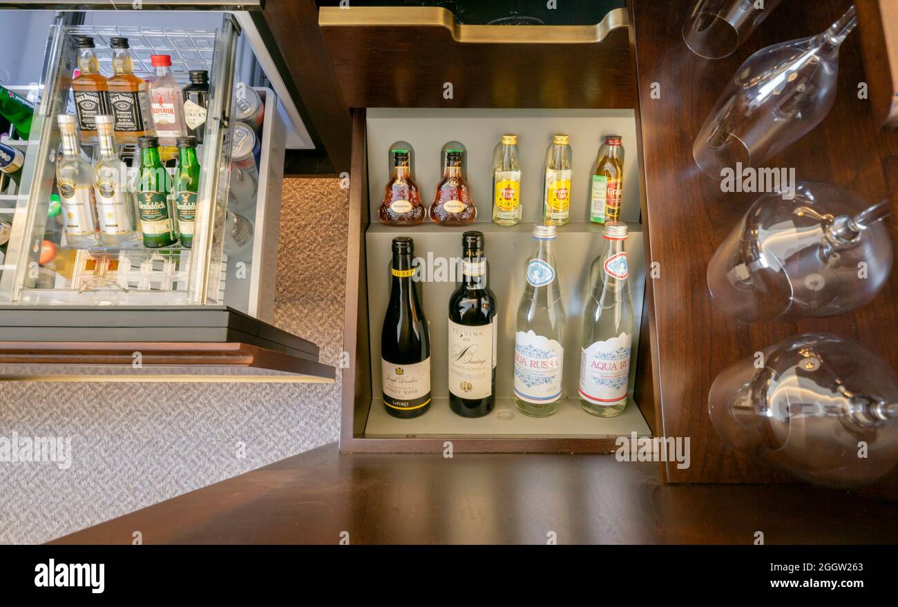 Wine bottles,glasses mini bottles in the mini bar of hotel room Stock Photo