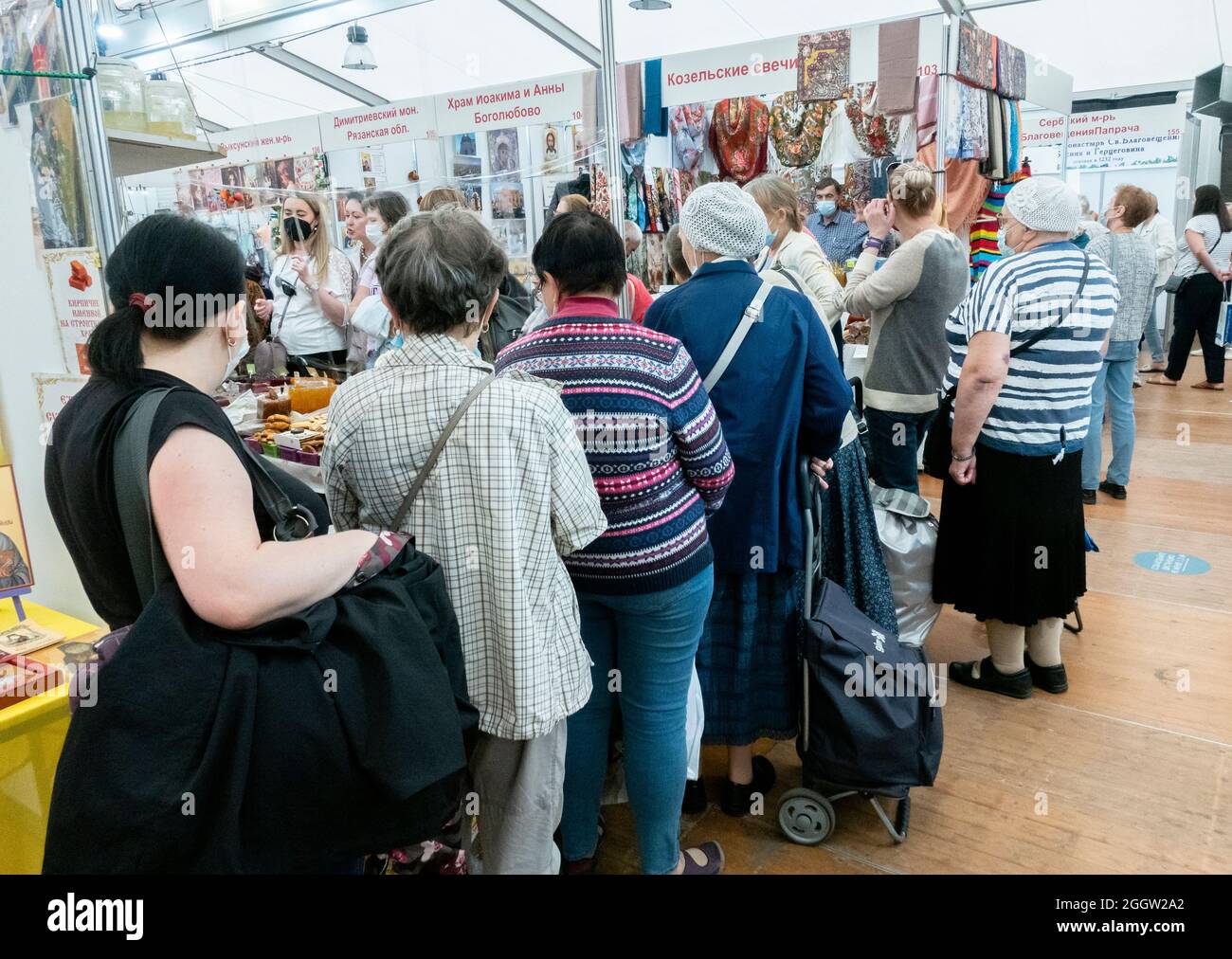 Back view of line of customers at kiosk at Orthodox fair, Moscow, Russia Stock Photo