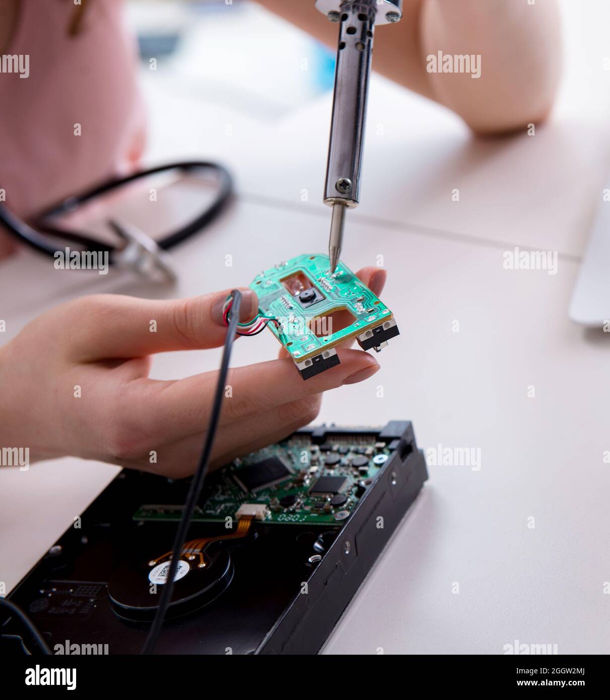 Fixing Computer Hard Way The engineer fixing broken computer hard drive Stock Photo - Alamy