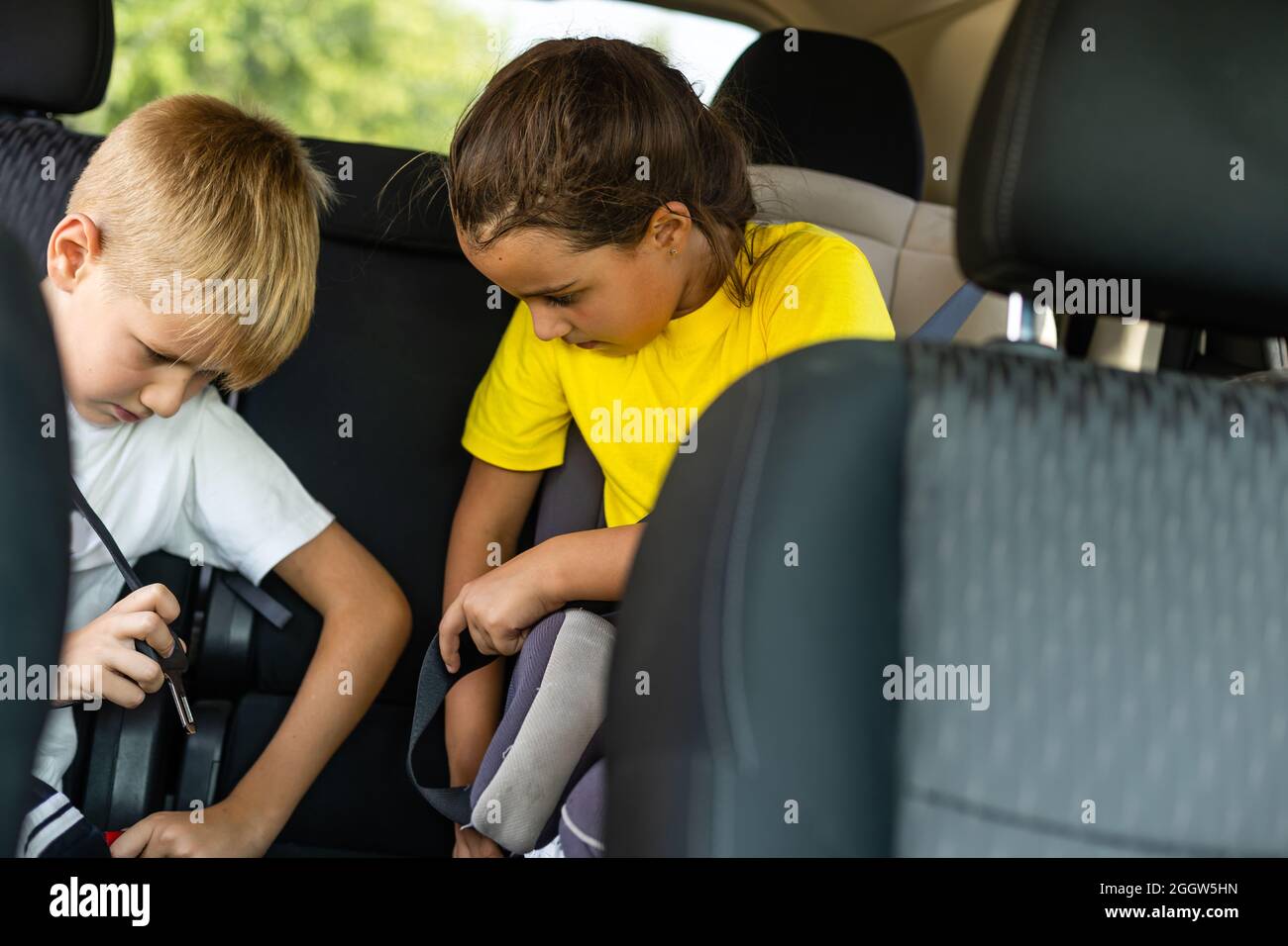 Smiling kids sitting on back seat of car Stock Photo - Alamy