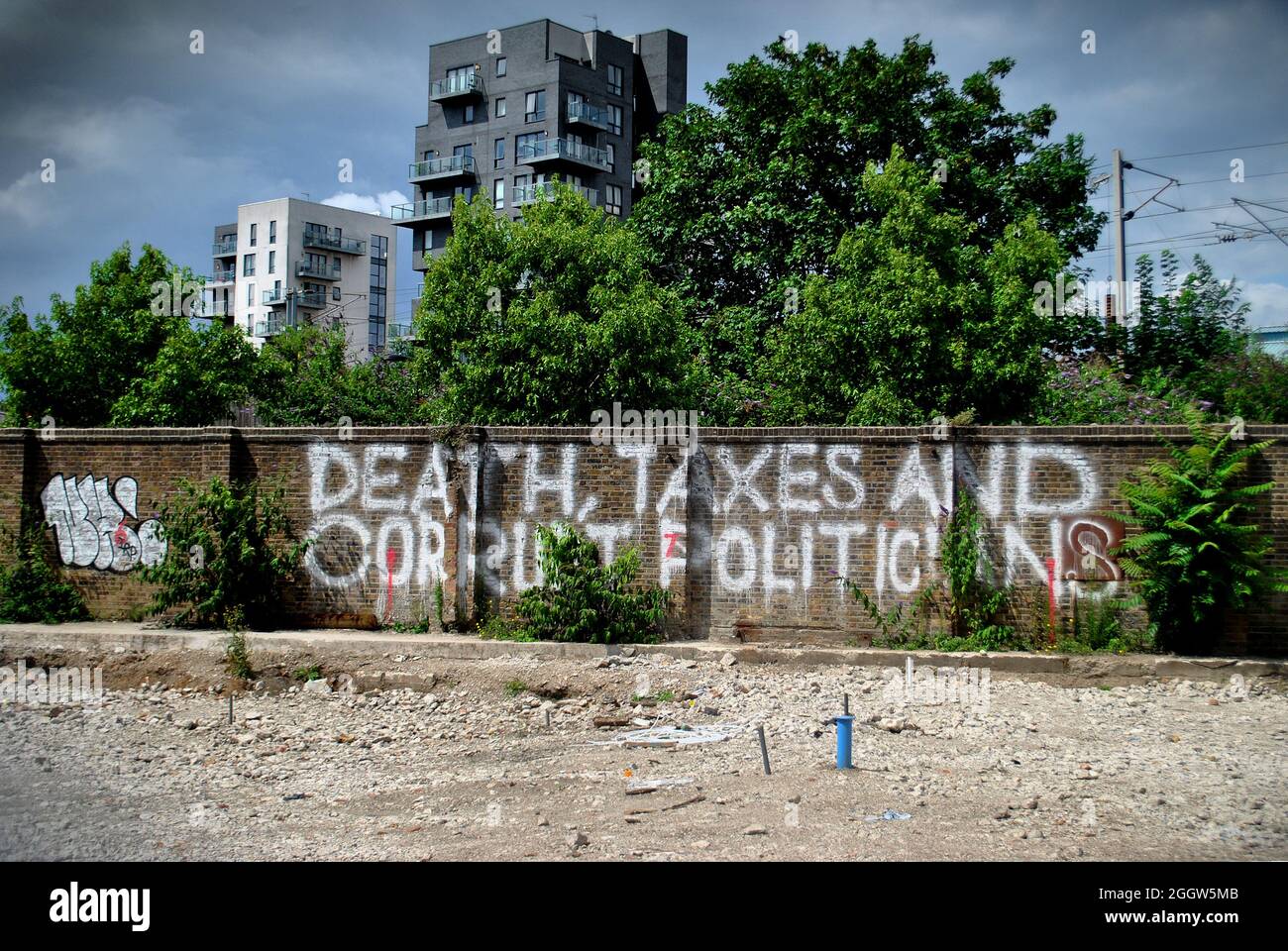 WRITTEN ON A WALL IN HACKNEY WICK IS DEATH,TAXES AND CORRUPT POLITICIANS. Stock Photo