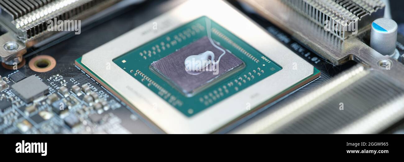Thermal paste lying on microchip for video card closeup Stock Photo
