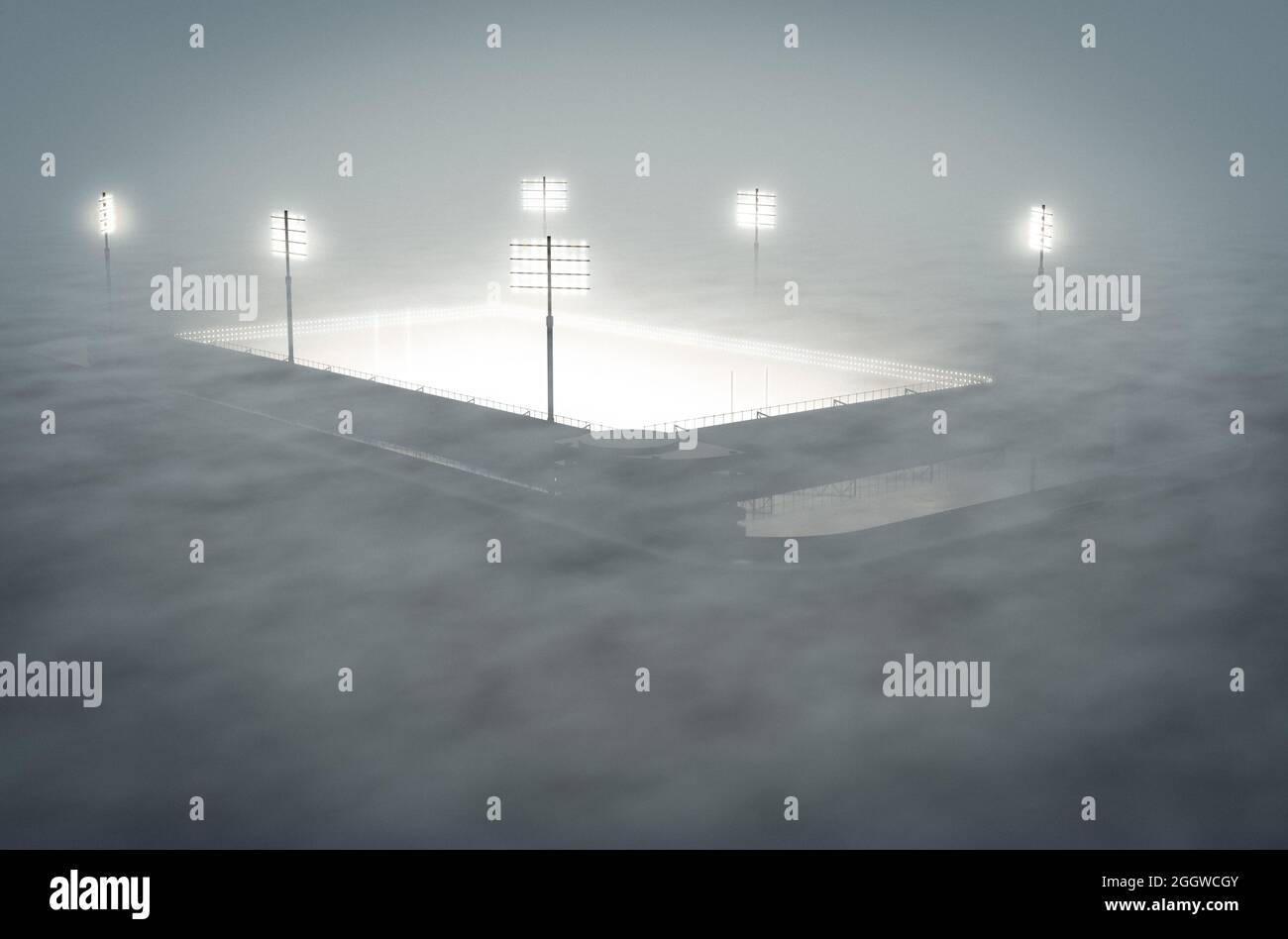 A rugby stadium illuminated by flood lights in the night covered by a thick misty atmosphere - 3D render Stock Photo