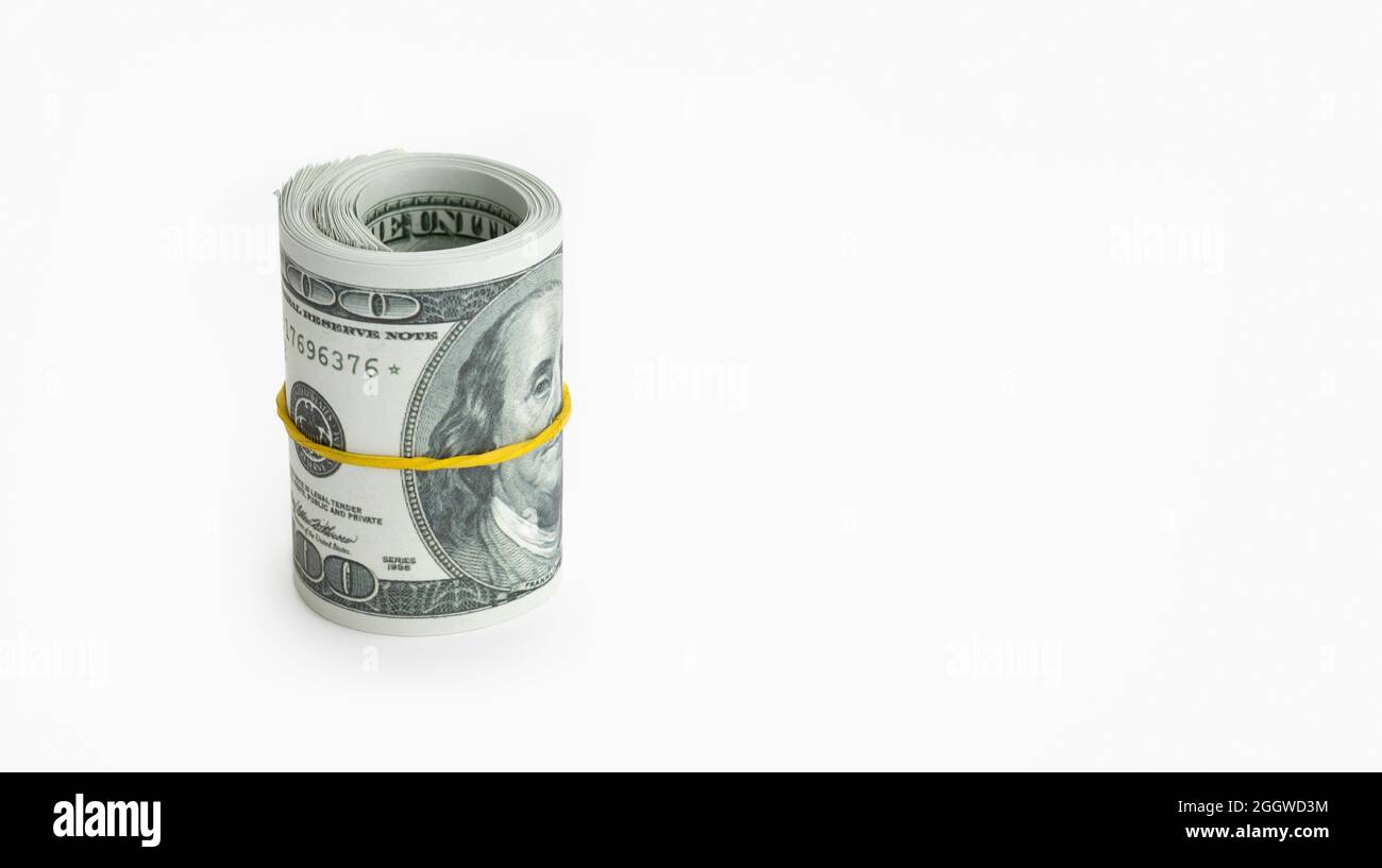 Roll of money wrapped in yellow elastic band isolated on white background. US dollar banknote. Copy space Stock Photo