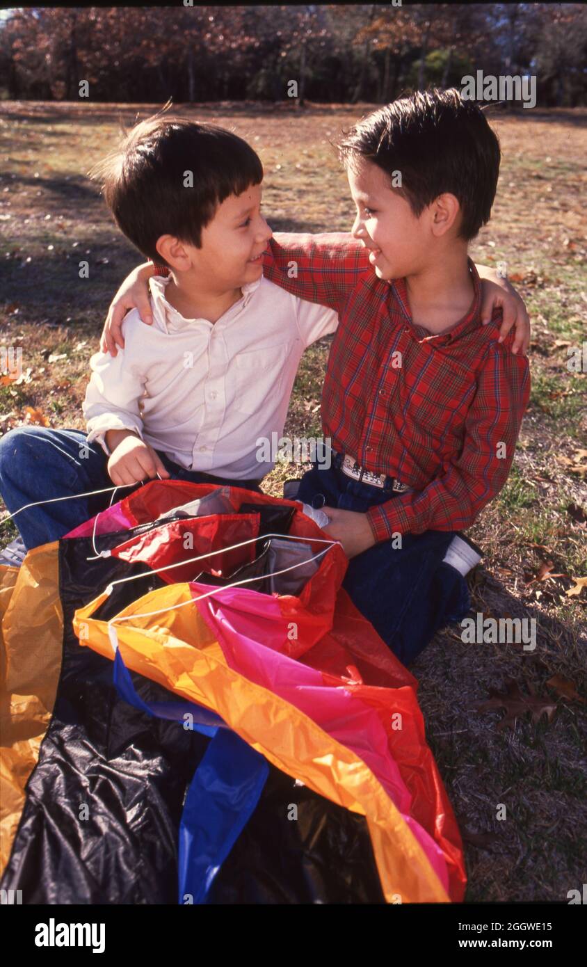 Two boys with arms around each other hi-res stock photography and ...