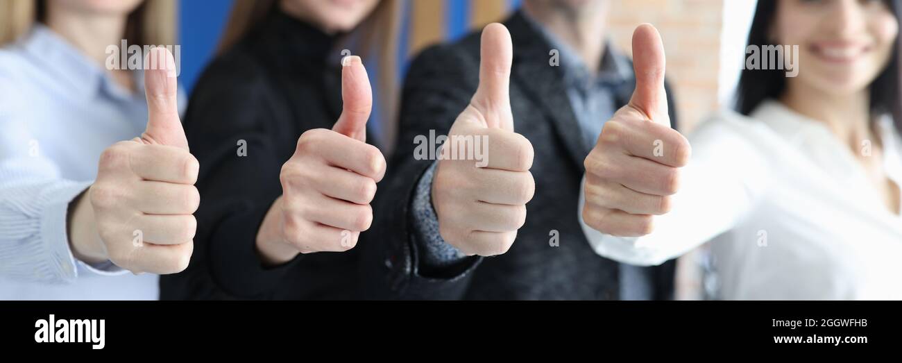 Group of business people showing thumbs up closeup Stock Photo - Alamy