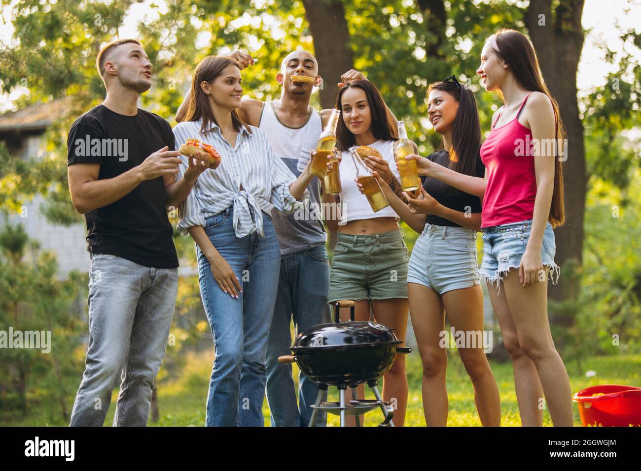 Full-length portrait of young joyfull friends hanging out in ...