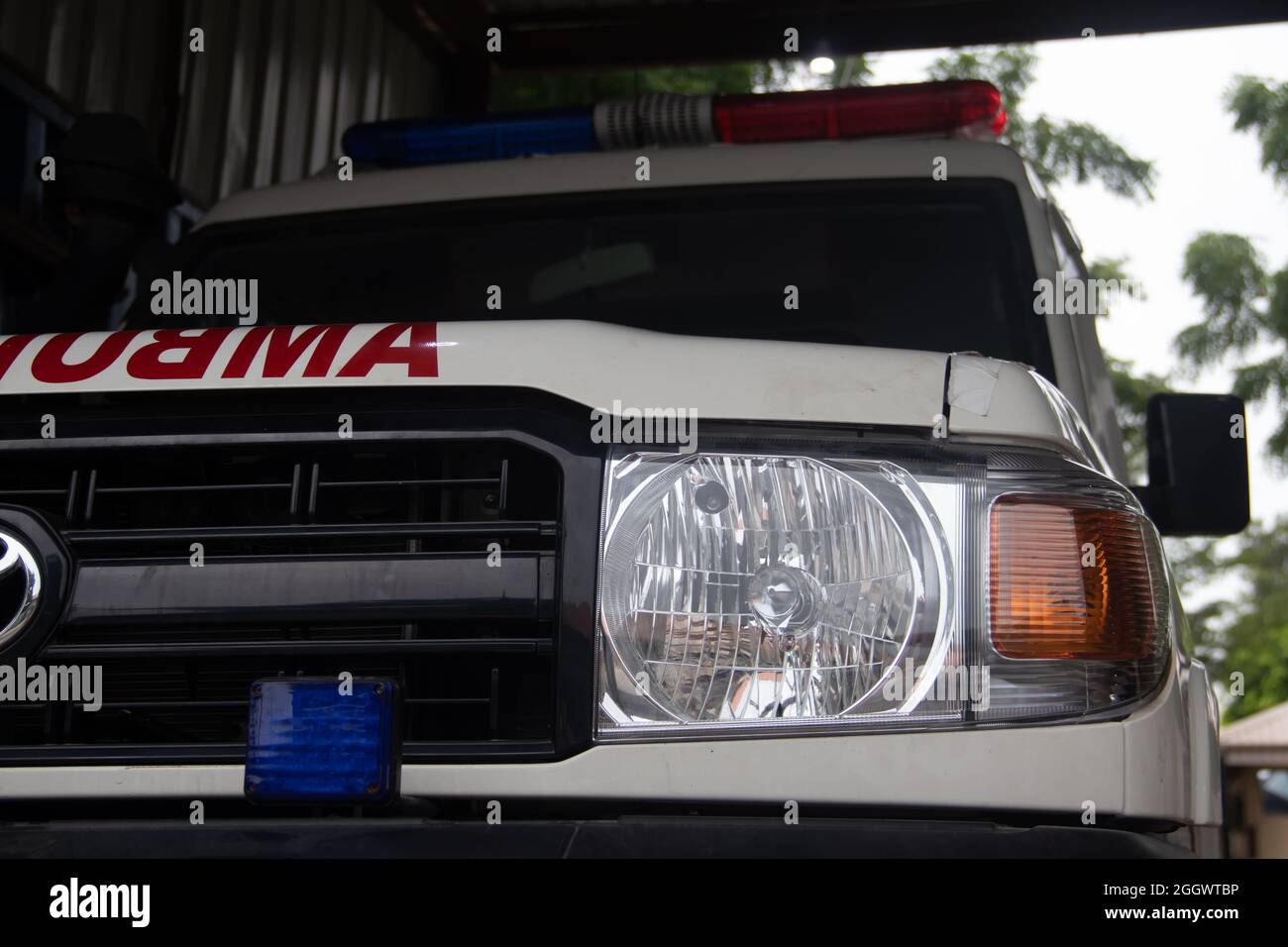 Close up of Ambulance vehicle ready for departure for emergency medical assistance, with visible medical red cross and emergency lights and siren Stock Photo