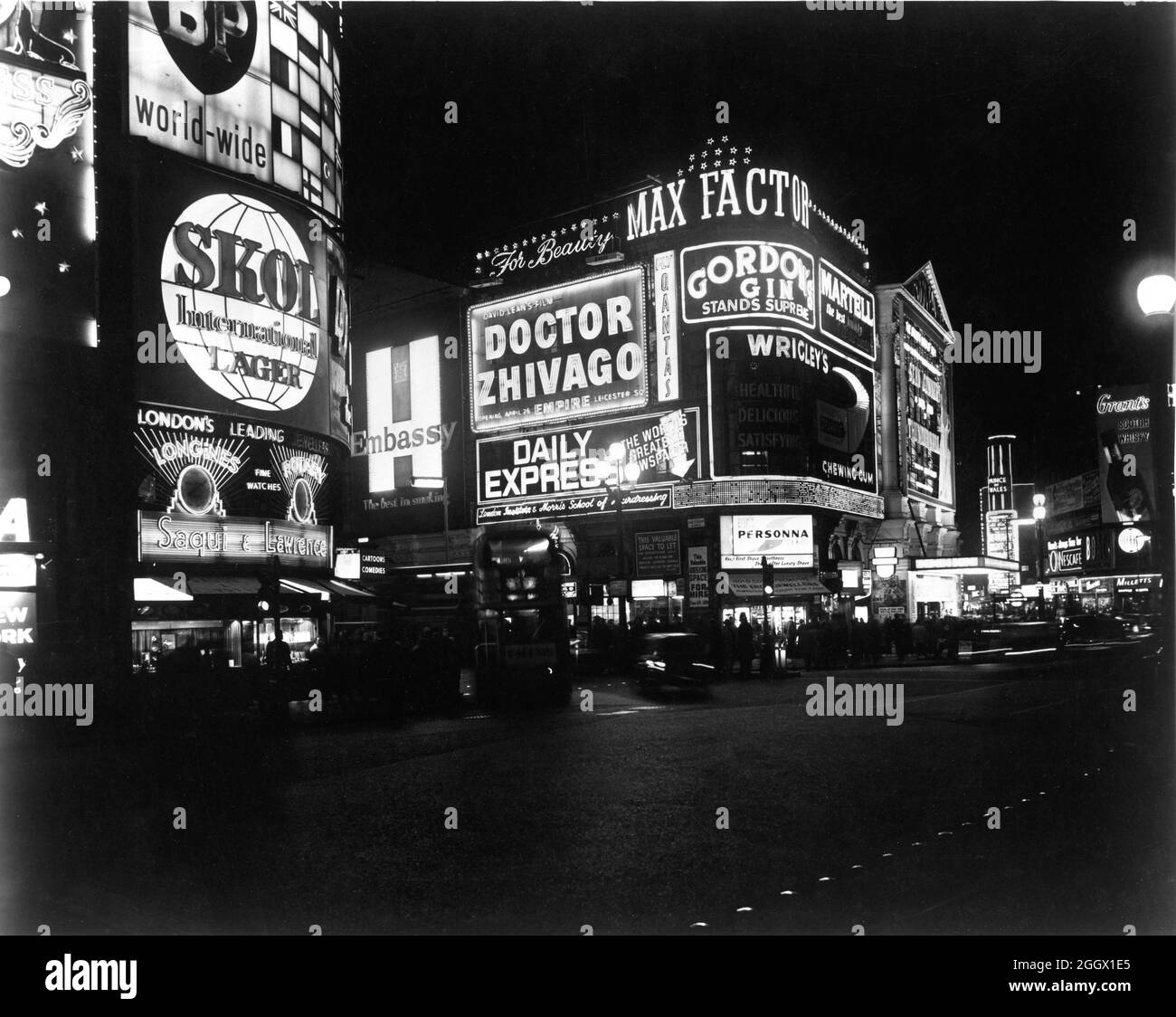LONDON PAVILION cinema on Piccadilly Circus, London in early 1966 when it was presenting SEAN CONNERY as James Bond 007 in THUNDERBALL 1965 director TERENCE YOUNG producers Harry Saltzman and Albert R. Broccoli Eon Productions / United Artists with Illuminated Billboard trailering the forthcoming DOCTOR ZHIVAGO director DAVID LEAN for Metro Goldwyn Mayer at the Empire Theatre Leicester Square Stock Photo