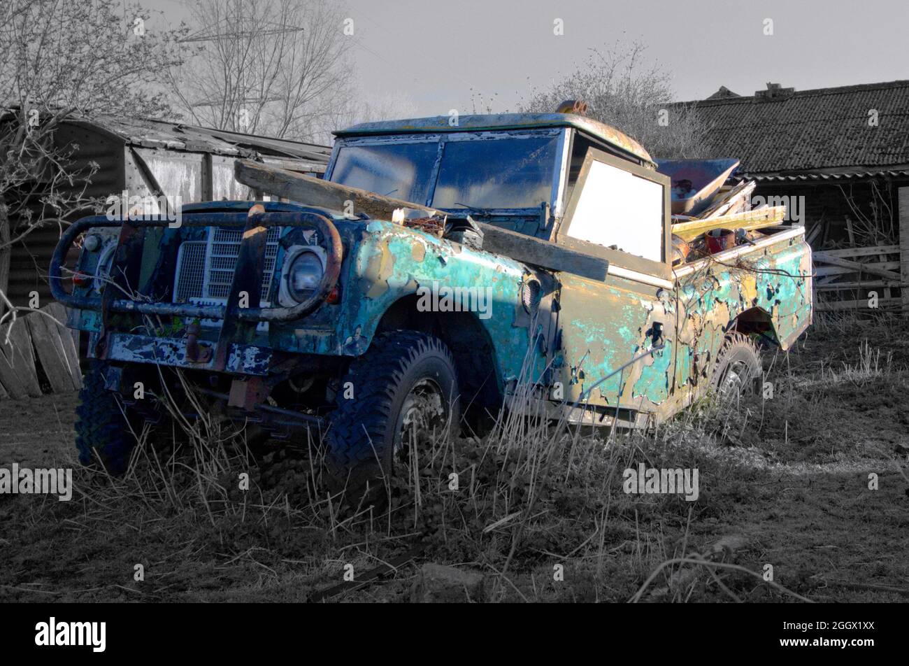 Abandoned land rover with broken chassis decays in a field. Stock Photo