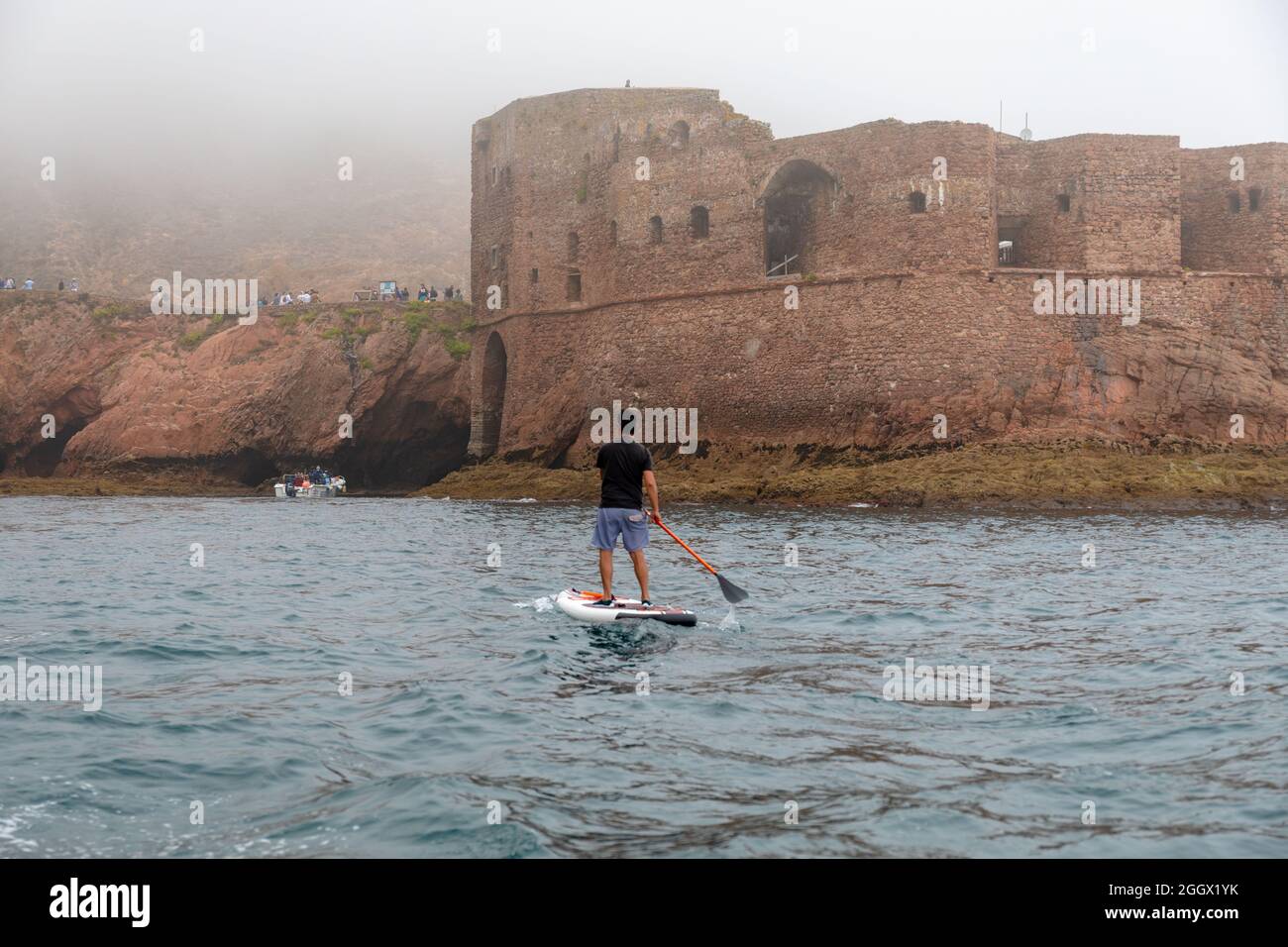 Man on paddle board in Berlenga Grande island, the largest island in the Berlengas archipelago, off the coast of Peniche, Portugal. Stock Photo