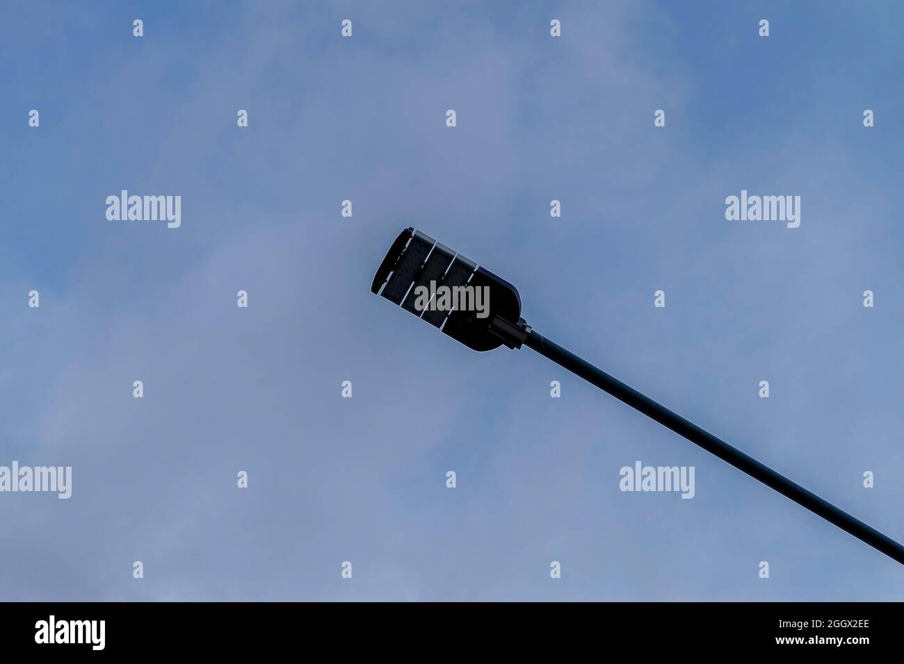 a street lighting lamp on a pole against the blue sky cloud background Stock Photo