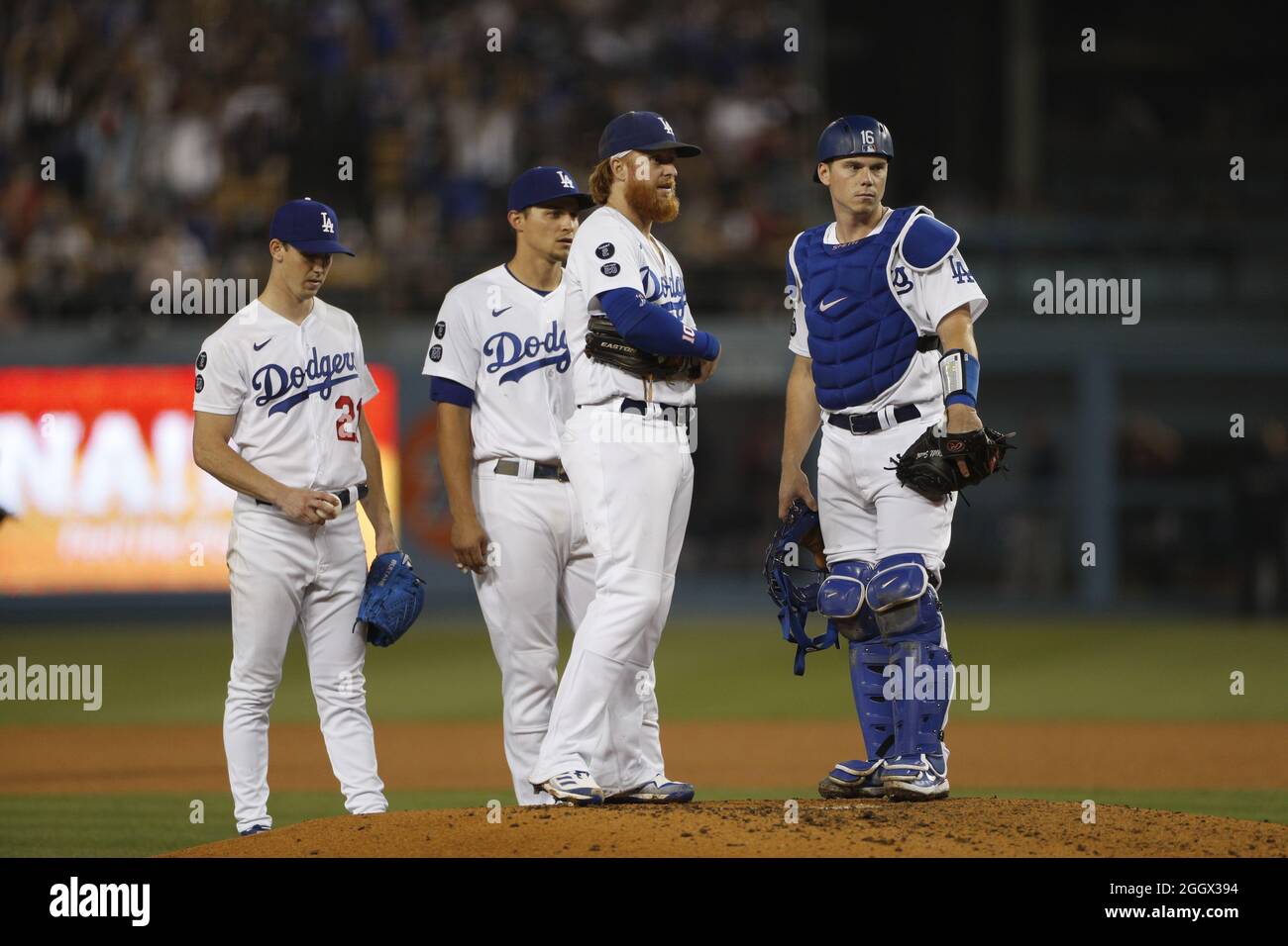 Los Angeles Dodgers players react to an injury sustained by Atlanta