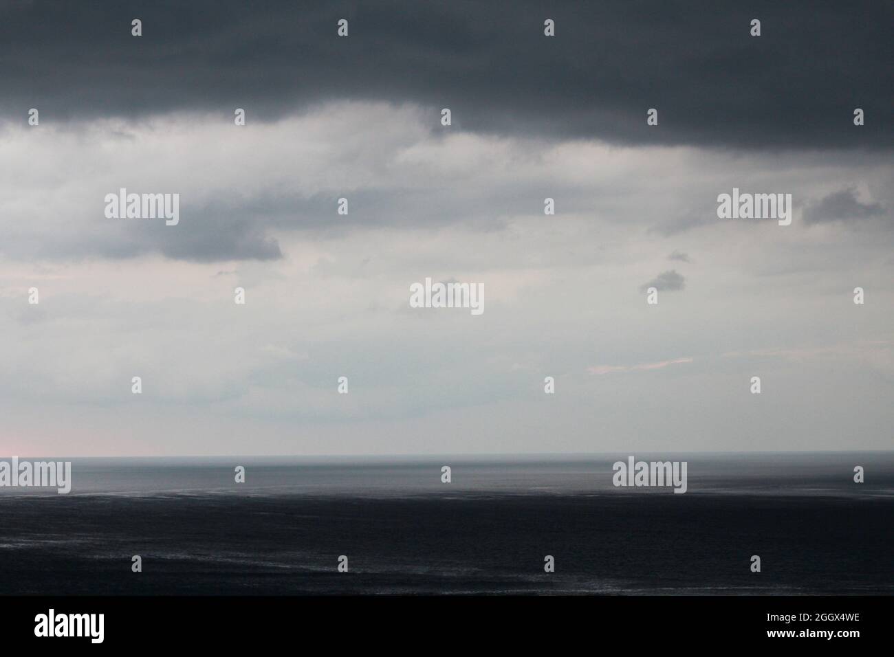 Dark sky and dramatic black cloud before rain. rain comming in the beach Stock Photo