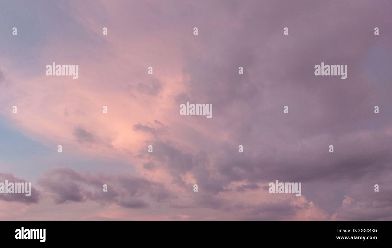Background of sunset with colorful cloudy sky in twilight time,fluffy cloud before rain Stock Photo