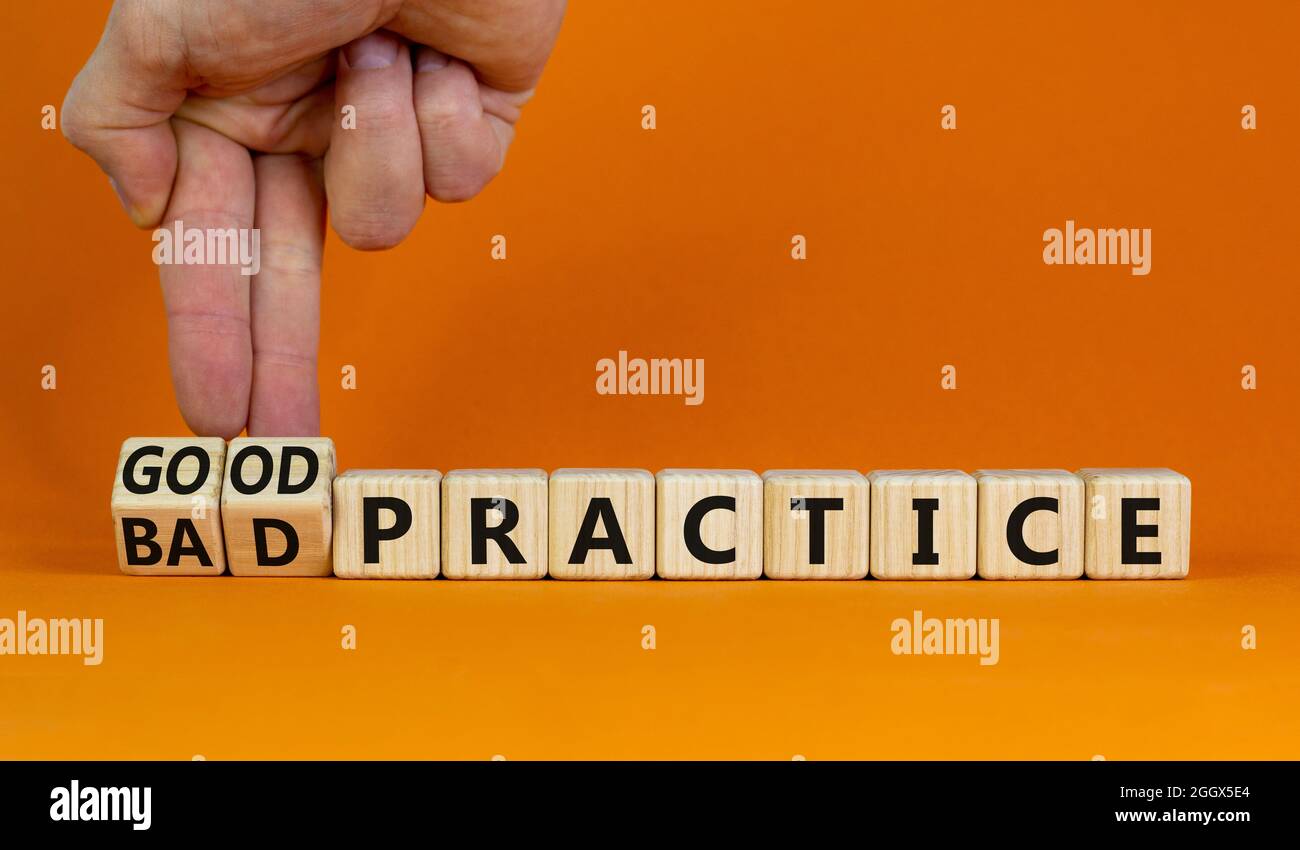 Good or bad practice symbol. Businessman turns wooden cubes and changes words 'bad practice' to 'good practice'. Beautiful orange background. Business Stock Photo