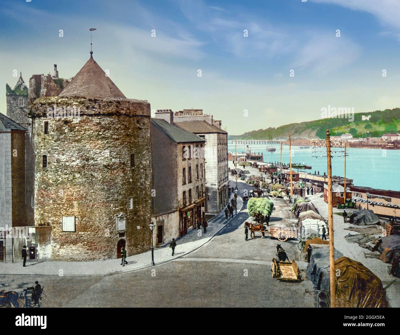 An early 20th century view of the south quays along the River Suir as it flows through Waterford, the oldest city in the Republic of Ireland. To the left is Reginald's Tower,  built by the Anglo-Normans after their conquest of Waterford, it replaced an earlier Viking fortification in the 13th century. During the 17th and 18th centuries the Tower was used as a munitions store and in the early 19th century it became the residence of the Chief Constable of Waterford. Stock Photo