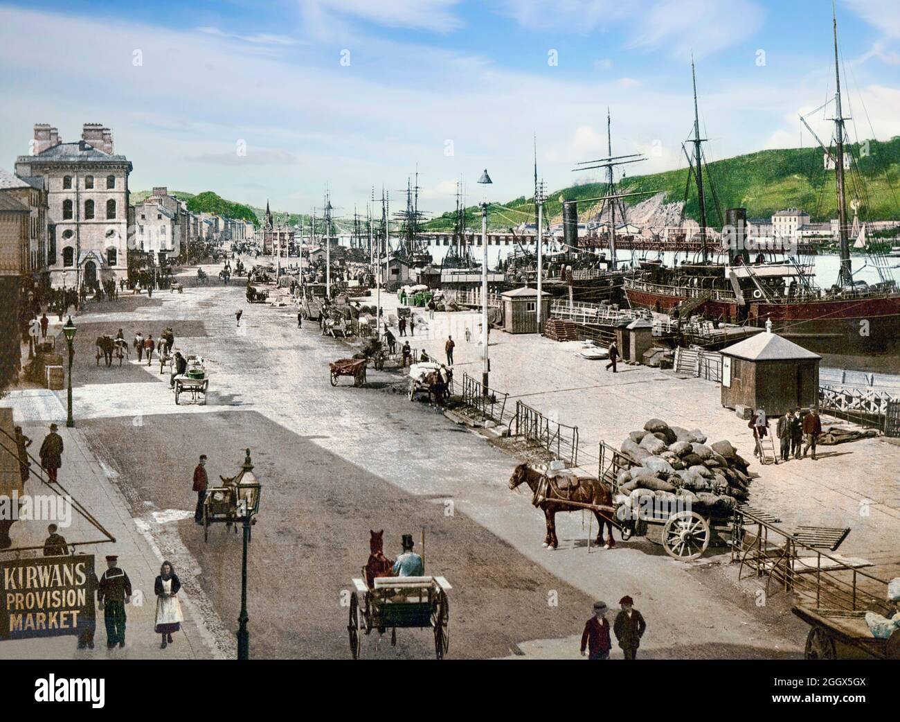An early 20th century view of shipping moored at the south quays along the River Suir as it flows through Waterford, the oldest city in the Republic of Ireland. In the early 1700s, the city walls facing the river were demolished and the remains used to widen the quays. Stock Photo