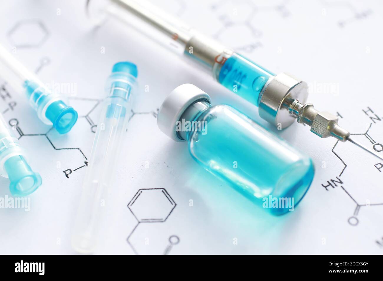 small jars with injection and syringe for injection on blue background ...