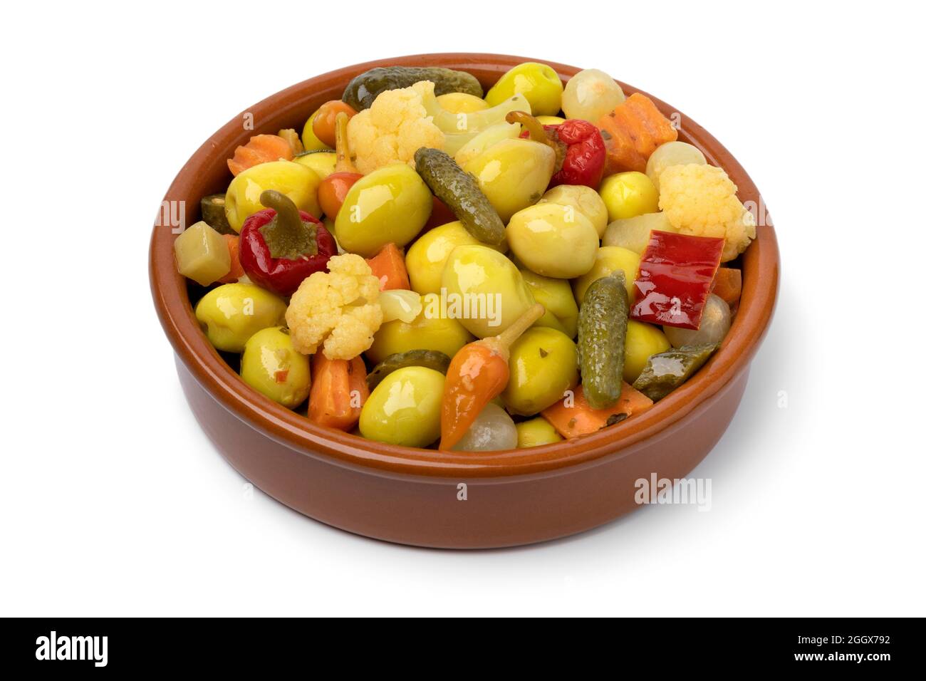 Traditional bowl with green olives and vegetables for a snack, appetizer or side dish isolated on white background Stock Photo