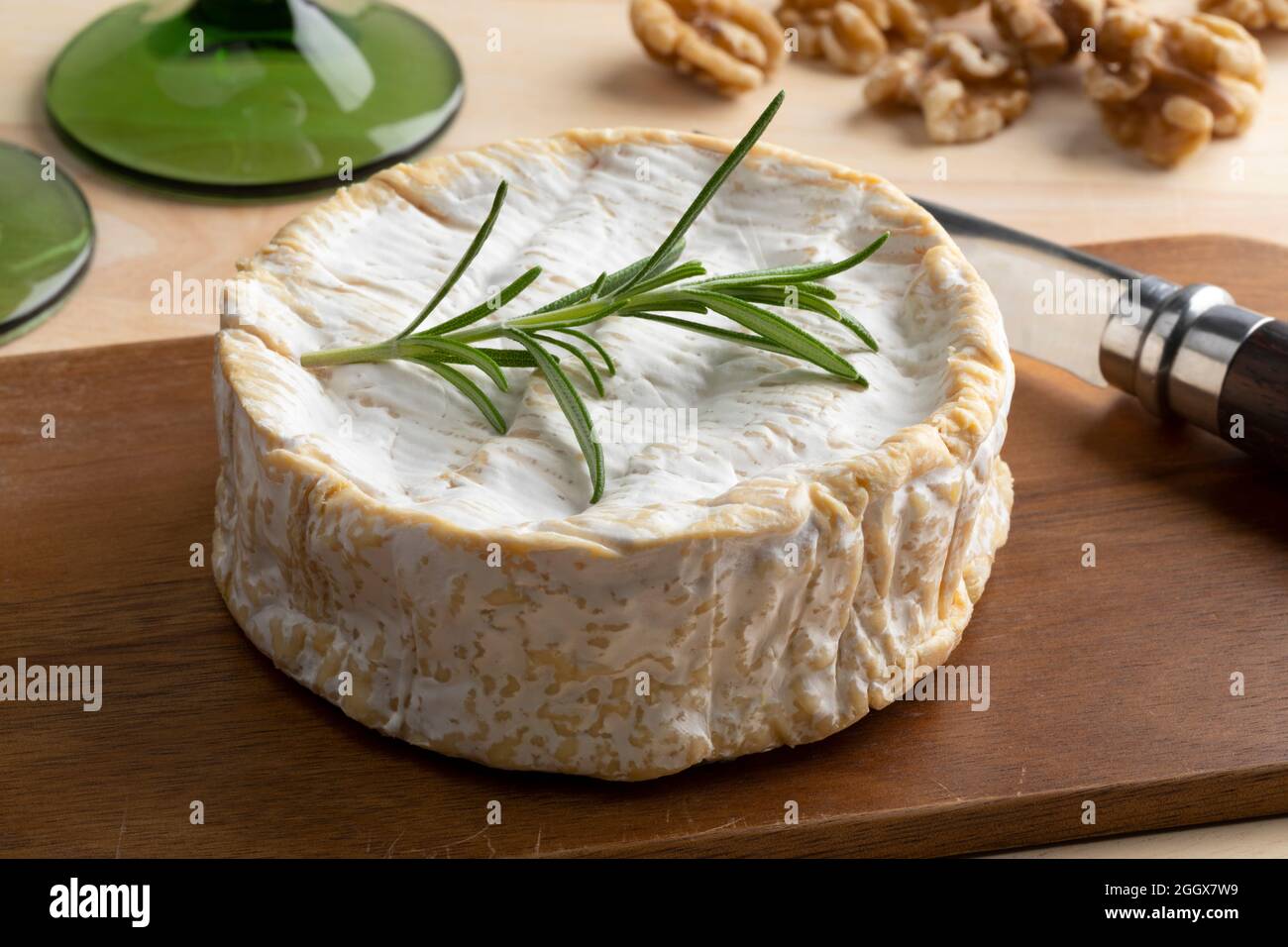 Traditional whole soft raw milk French Camembert cheese close up on a cutting board Stock Photo