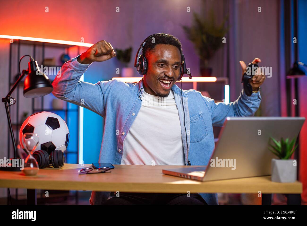 Free Photo  Player winning video games with controller and headset in  front of monitor. man using joystick and headphones, playing online games  on computer. person celebrating game win for leisure.