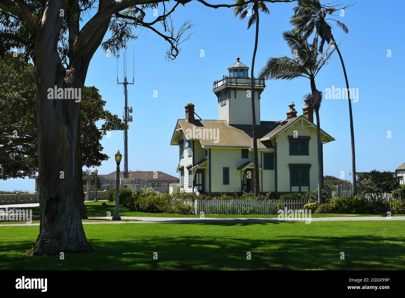 SAN PEDRO, CALIFORNIA - 27 AUG 2021: Point Fermin Lighthouse, framed by trees, is on the National Register of Historic Places. Stock Photo
