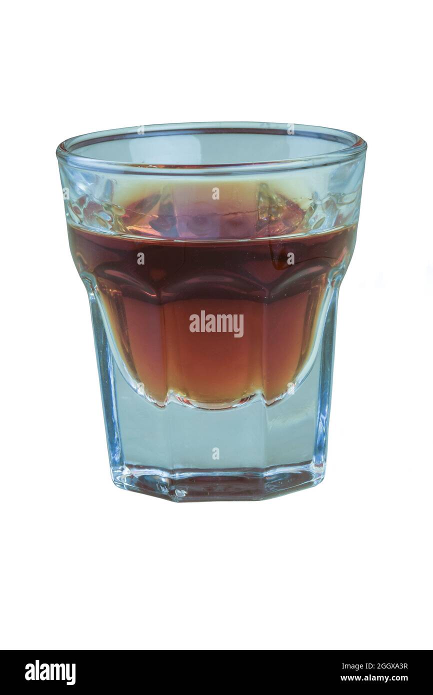 A glass of brandy on a white background is shot very close up Stock Photo