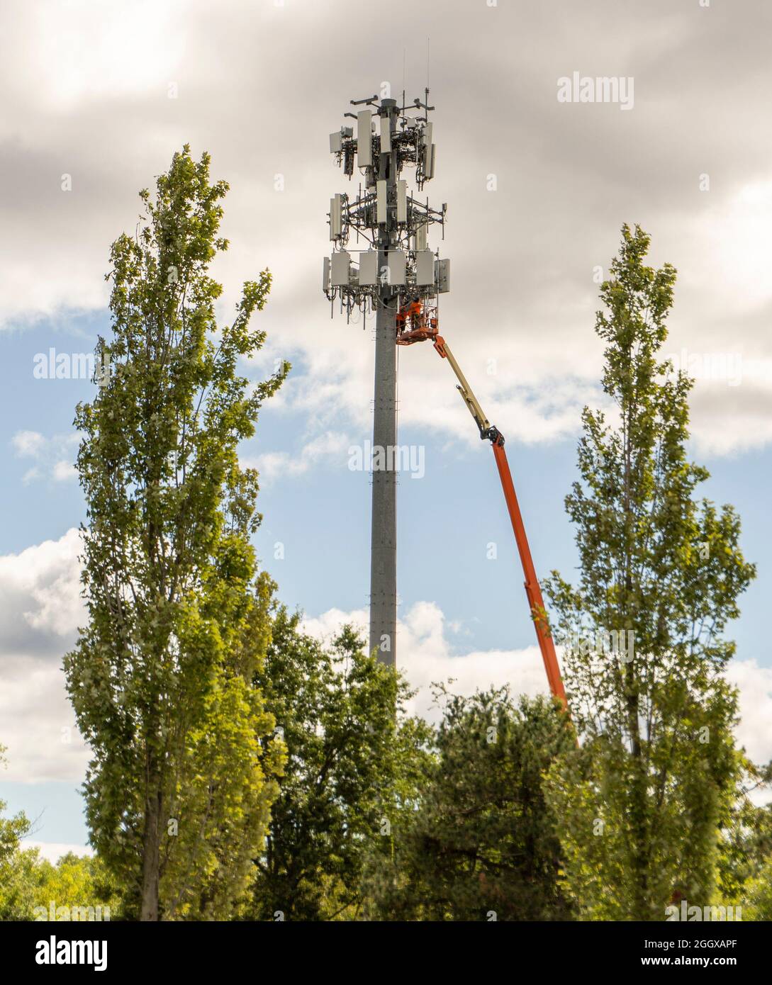 A cell tower being repaired Stock Photo