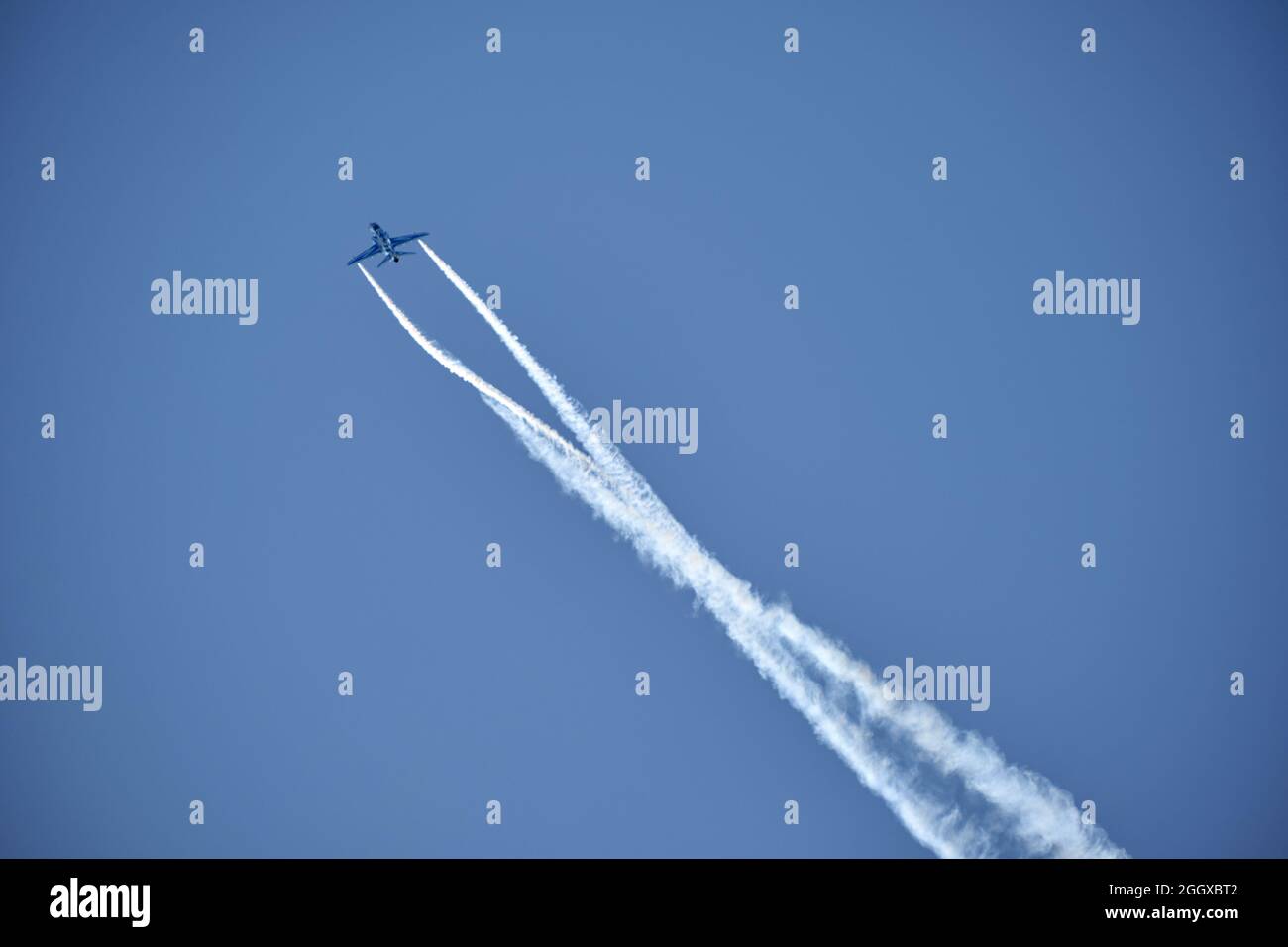 Acrobatics of the plane with wing smoke Stock Photo