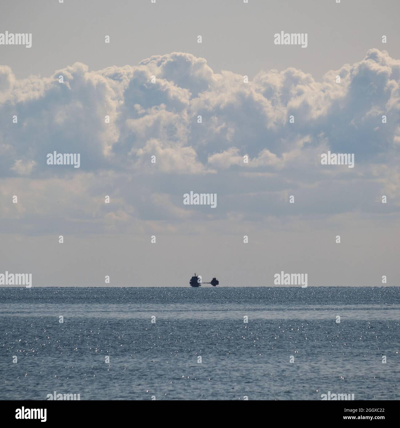 Distant lanscape with sea horizon, clouds and vessel Stock Photo