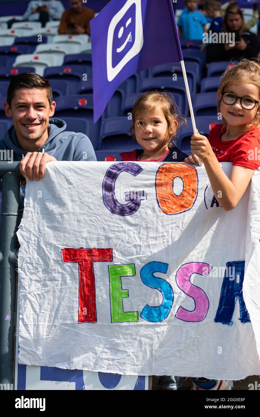 Father with two young daughters supporters for Tessa Wullaert, a striker at the RSCA women soccer team Stock Photo