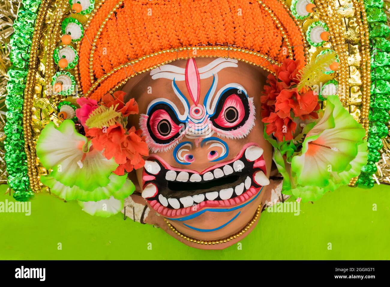 Colorful Chhau (or chhou) mask of a demon, called Asur in Hindu mythology, handicrafts on display for sale - at Charida, Purulia - Bangla. Chou dance. Stock Photo