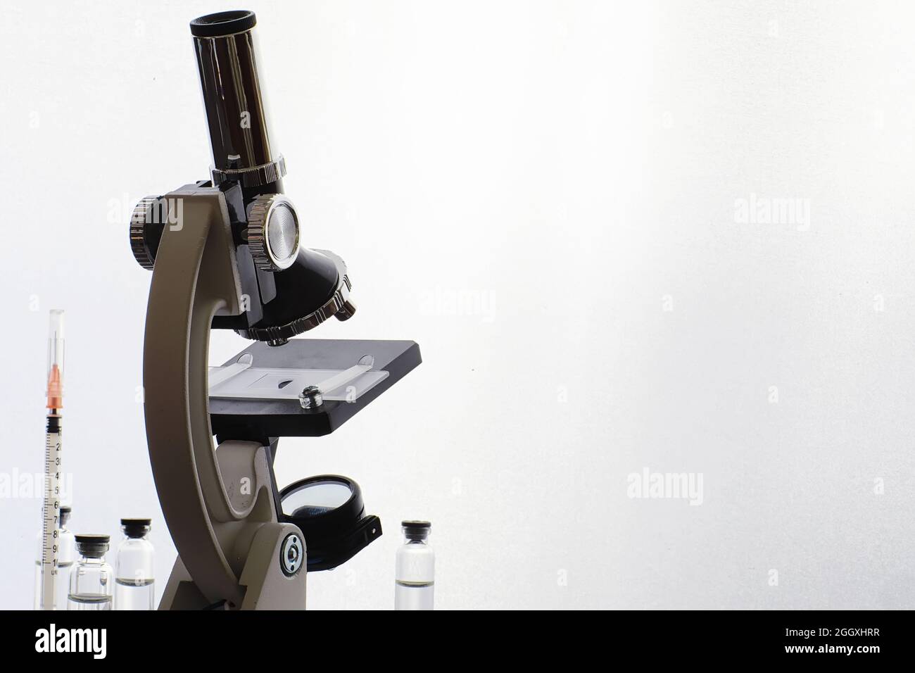 Research laboratory. Test tubes and microscope on the table on a white ...