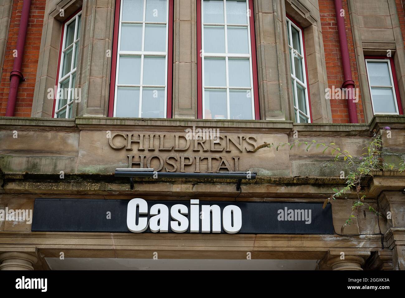 An amusing or sad juxtaposition of the old Children's Hospital sign and the new Casino sign. Health to wealth! Hospital to gambling den. Stock Photo