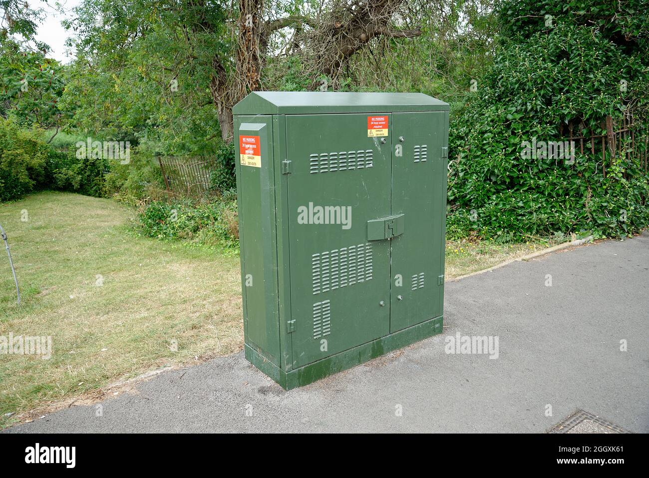 Green telecom switch housing boxes. Street cabinets with fibre optic and copper telephone/broadband lines. Stock Photo