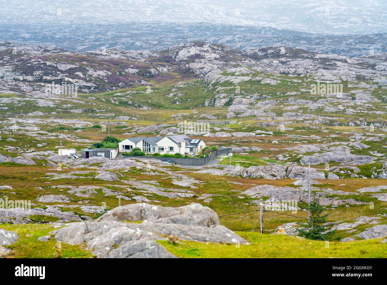 View of on solitary house amongst rocky barren landscape on The Bays on East coast of Isle of Harris, Outer Hebrides, Scotland, UK Stock Photo