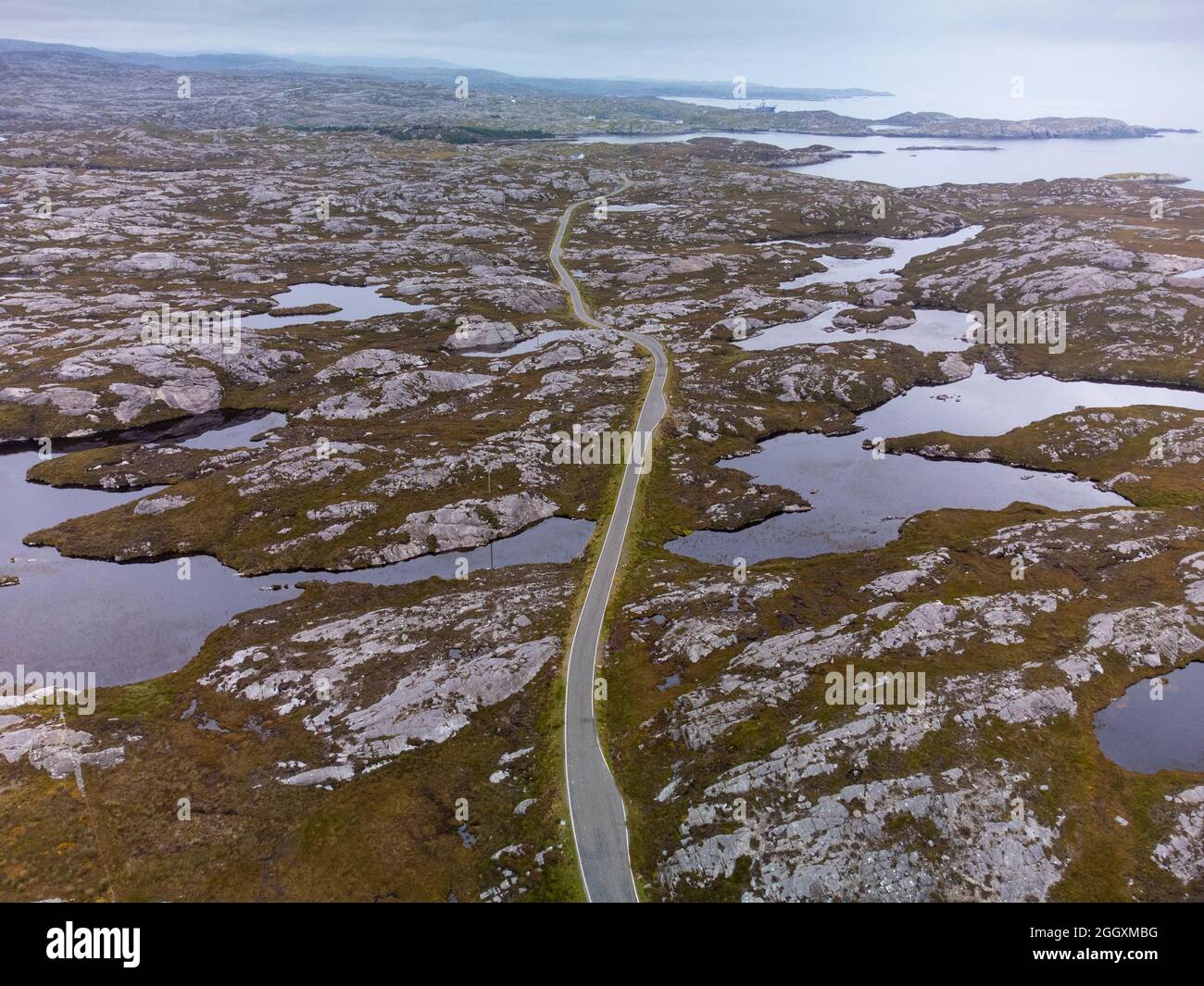 Aerial view from drone of narrow road and rocky landscape on The Bays on East coast of Isle of Harris, Outer Hebrides, Scotland, UK Stock Photo