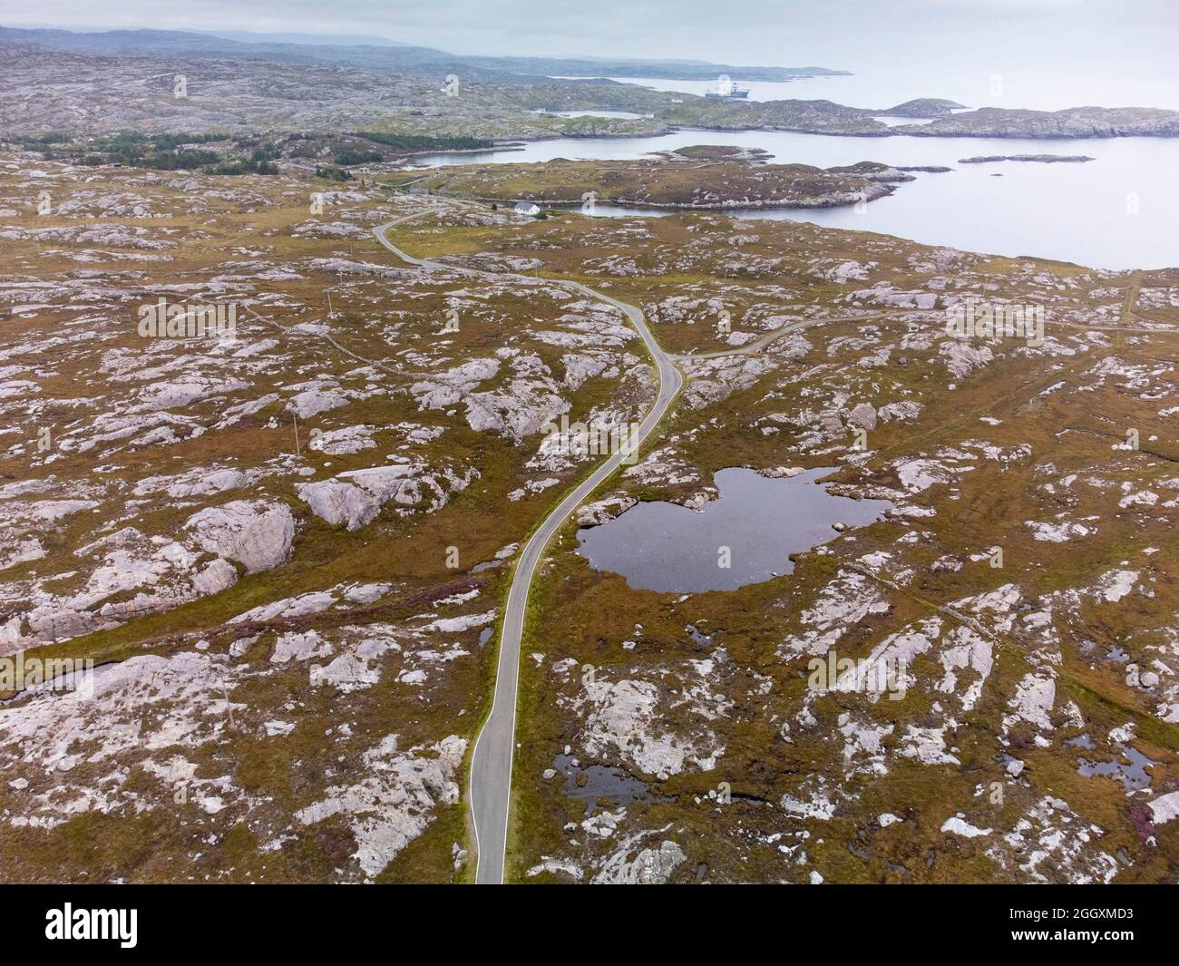 Aerial view from drone of narrow road and rocky landscape on The Bays on East coast of Isle of Harris, Outer Hebrides, Scotland, UK Stock Photo