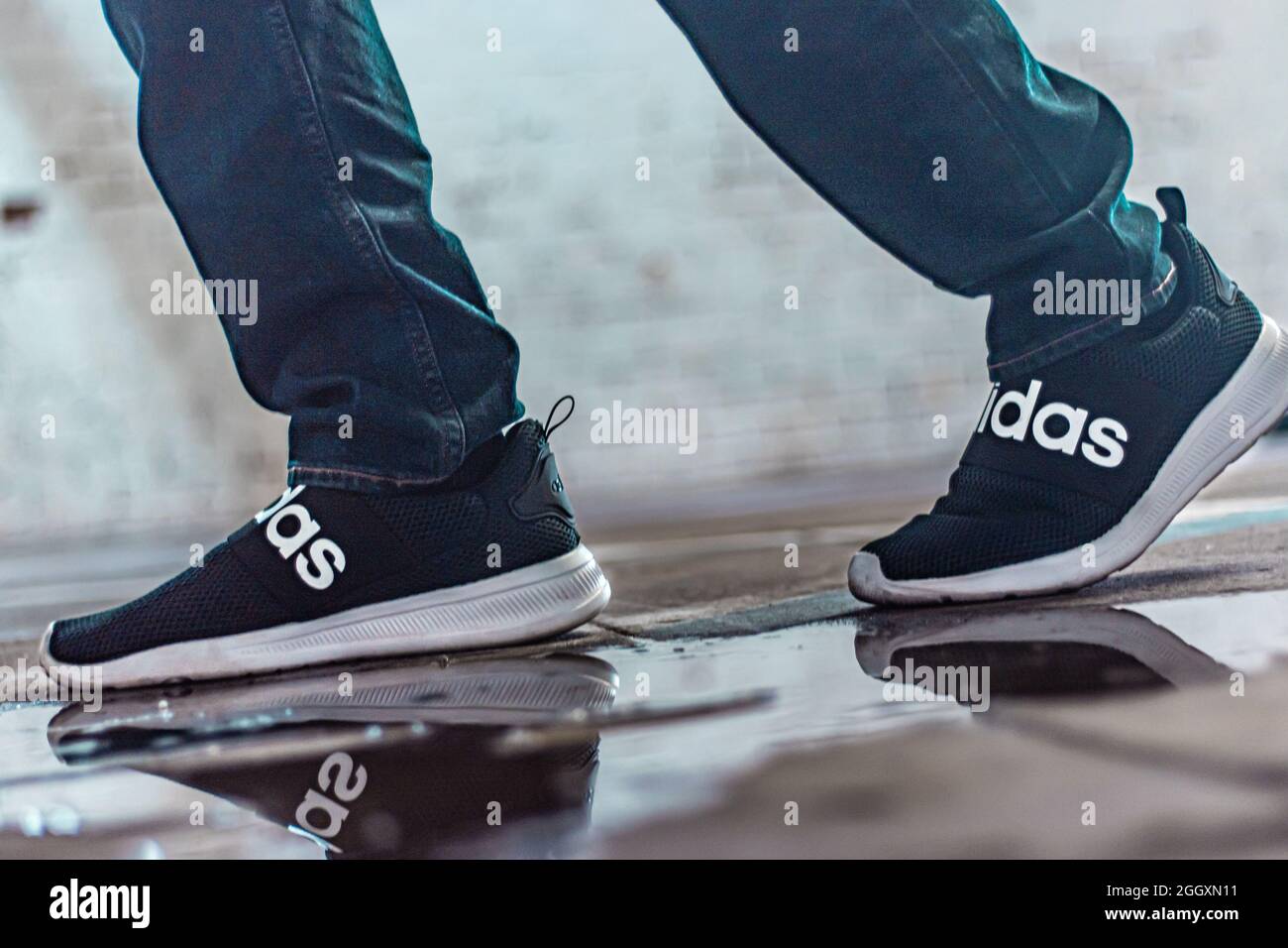 LINCOLN, UNITED STATES - Aug 09, 2021: A closeup shot of Adidas shoes with  a nice reflection in the water Stock Photo - Alamy