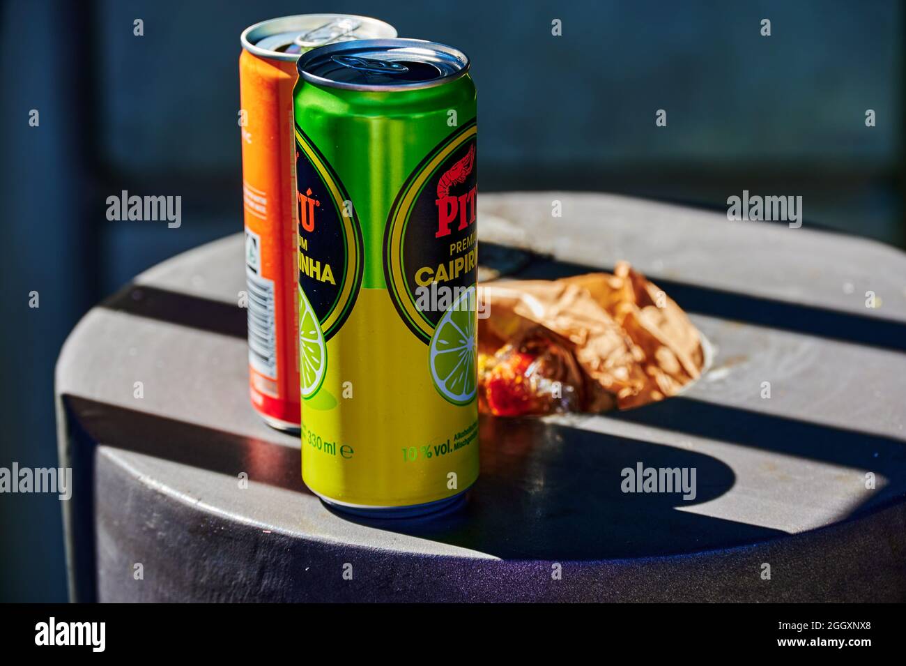 Schoenefeld, Germany - September 3, 2021: Two empty beverage cans that have been placed on a full trash can. Stock Photo