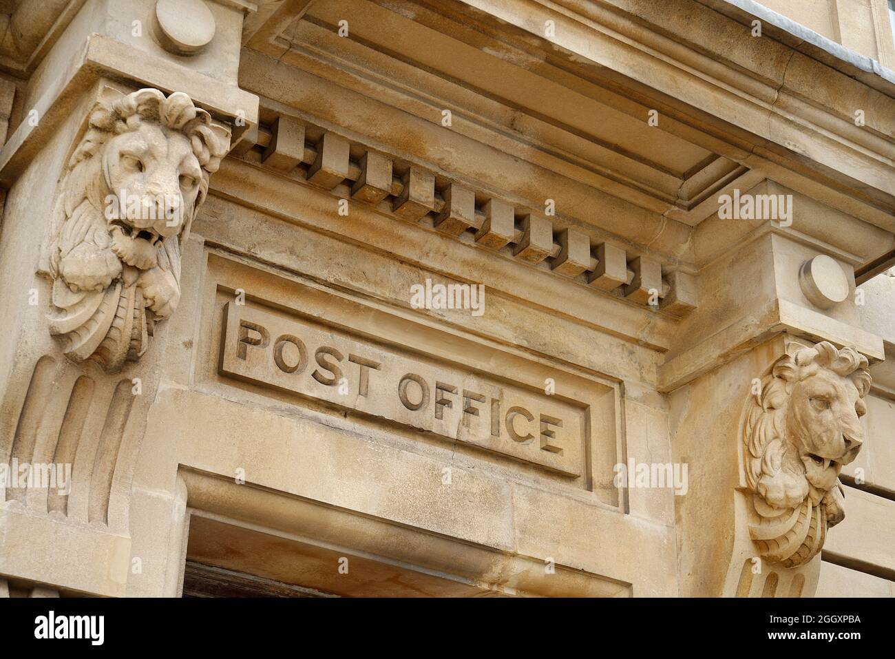 An old Post Office entrance doorway or portico. A grand stone facade with carved stone lions. A regal and important place to go. Stock Photo