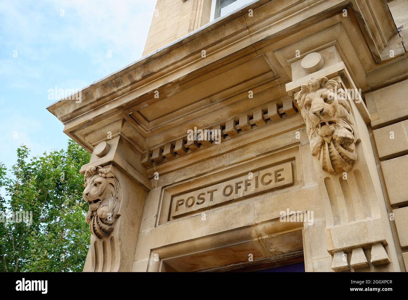 An old Post Office entrance doorway or portico. A grand stone facade with carved stone lions. A regal and important place to go. Stock Photo