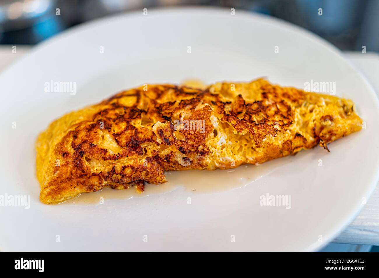 Making omelettes - folding over plain omelette using a large spatula Stock  Photo - Alamy