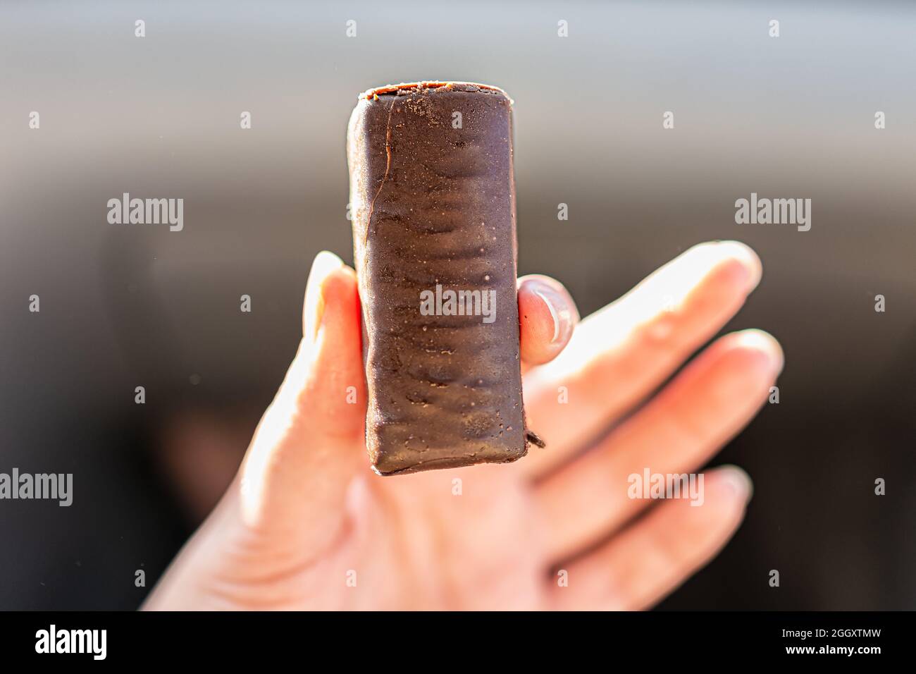 Storebought Russian delicious cheesecake candy bar hand holding with