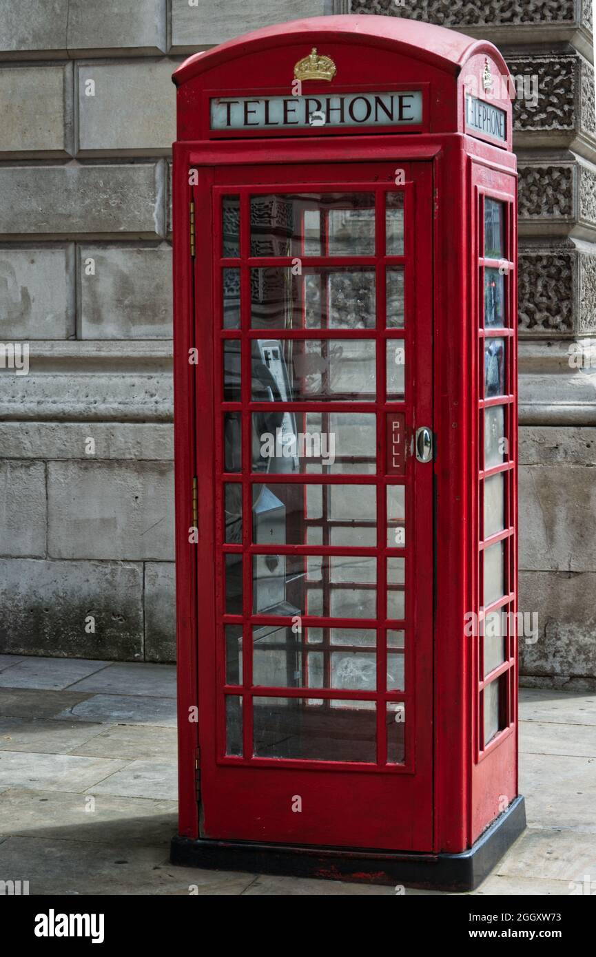 Iconic British red telephone box on the street in London Stock Photo
