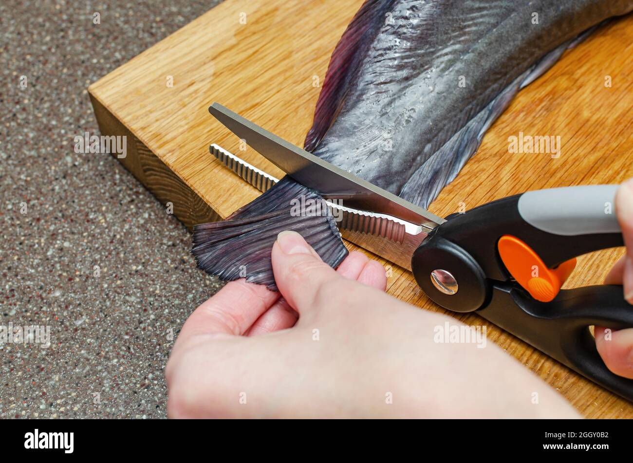 Before grilling, the restaurant chef cuts off the fins and tail of