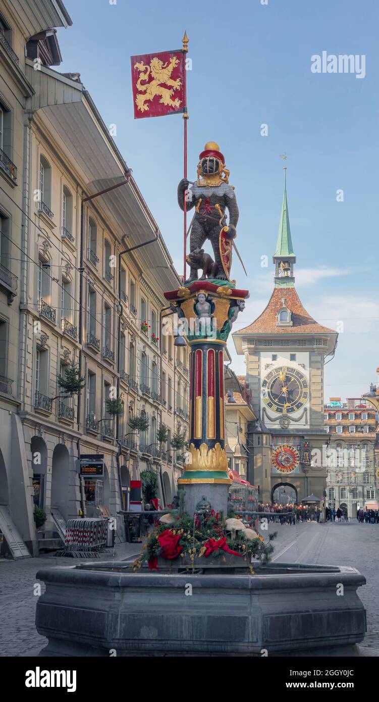 Zahringen Fountain (Zahringerbrunnen) with  Zytglogge Clock Tower on background - one of the medieval fountains of Bern Old Town - Bern, Switzerland Stock Photo